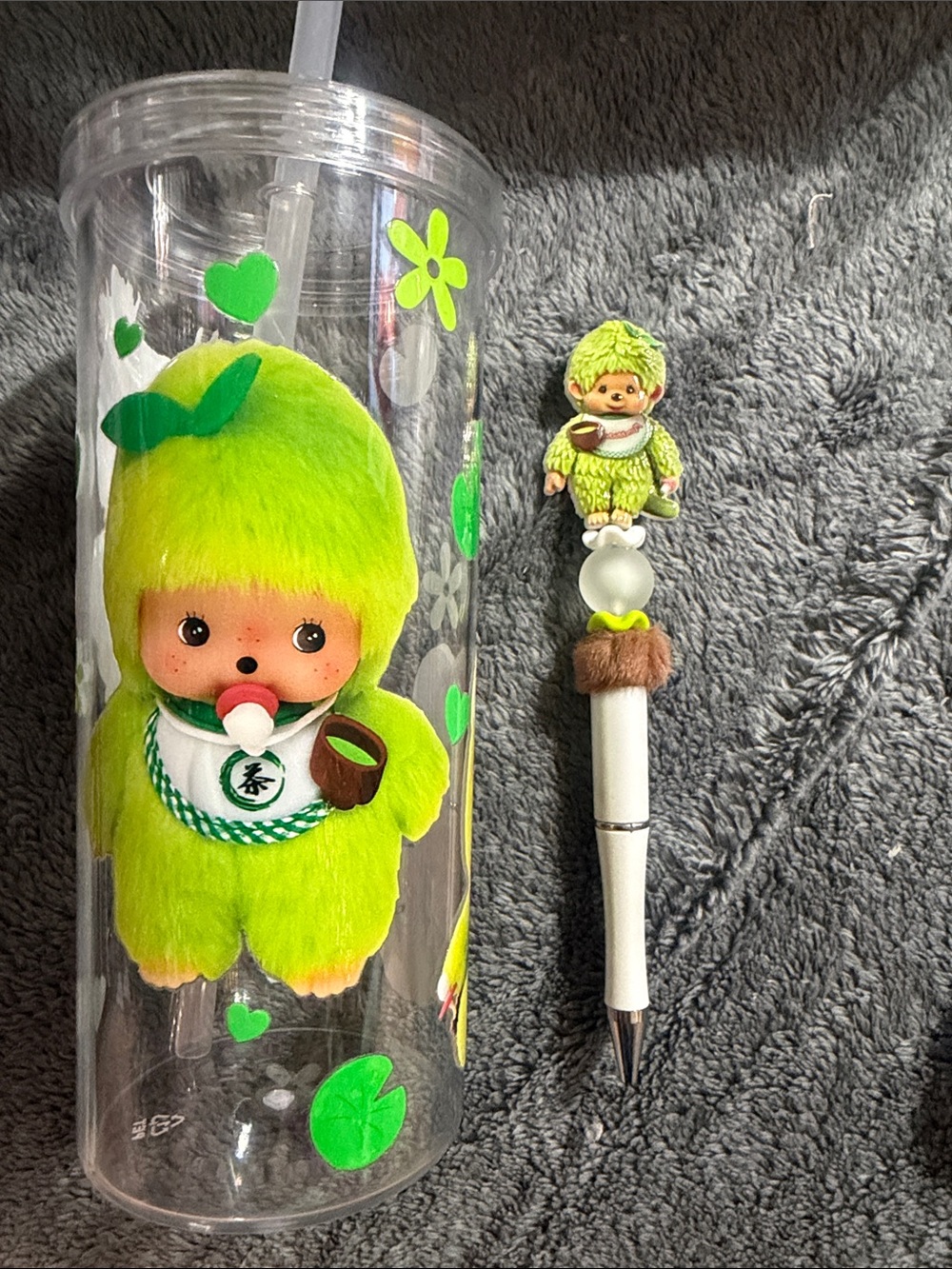 Green Monichichi acrylic tumbler with matching pen.